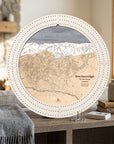 Arctic White Breckenridge ski map cribbage board displayed on a wooden console beside books and a gray blanket