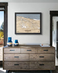 Wooden framed skiing map of Gore Mountain in a bedroom.