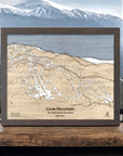 Framed wooden map of Gore Mountain ski resort with mountain view in the background