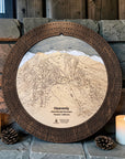 Heavenly Ski Trail Map Cribbage Board handcrafted from wood, featuring an engraved Heavenly ski resort trail map surrounded by a dark walnut cribbage track, displayed on a rustic stone fireplace mantel with candles and pinecones.