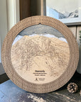 Handcrafted Heavenly Ski Trail Map Cribbage Board with a natural oak cribbage track, featuring an engraved wooden map of Heavenly Ski Resort, displayed on a mountain-inspired tabletop with pinecones, evergreen décor, and framed alpine artwork.