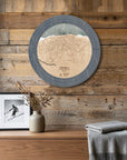 Killington ski trail map cribbage board displayed as round wall art above a rustic wood console inside a cozy ski cabin.