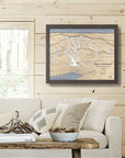 Framed 3D wood map of Mont Tremblant on a wooden wall above a sofa in a ski cabin