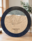 Ragged Mountain wooden cribbage board in Matte Onyx displayed near a sunlit window inside a mountain ski home.