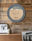 Ragged Mountain ski trail map cribbage board displayed as round wall art above a rustic wood console inside a cozy ski cabin.