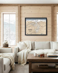 Cozy ski house with wooden walls, a map of Revelstoke Ski Resort, and white sofas.