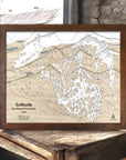 Framed topographic map of Solitude Ski Trails, in the Wasatch Mountains, Utah on a wooden surface.