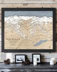 Whistler Blackcomb 3D wood ski map with a Matte Onyx frame on a whitewashed cabin wall above a rustic console.