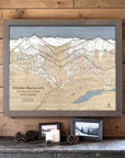 Storm Grey-framed Whistler Blackcomb wood ski map displayed on a warm timber wall with restrained cabin décor.