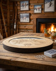 Heavenly ski map board game resting on a reclaimed wood coffee table in a warm mountain cabin.