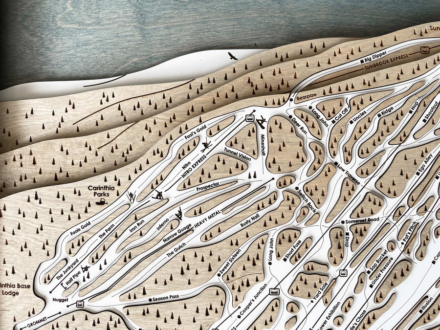 Laser engraved ski trails, chairlifts, and mountain artwork to create unique ski resort maps. 