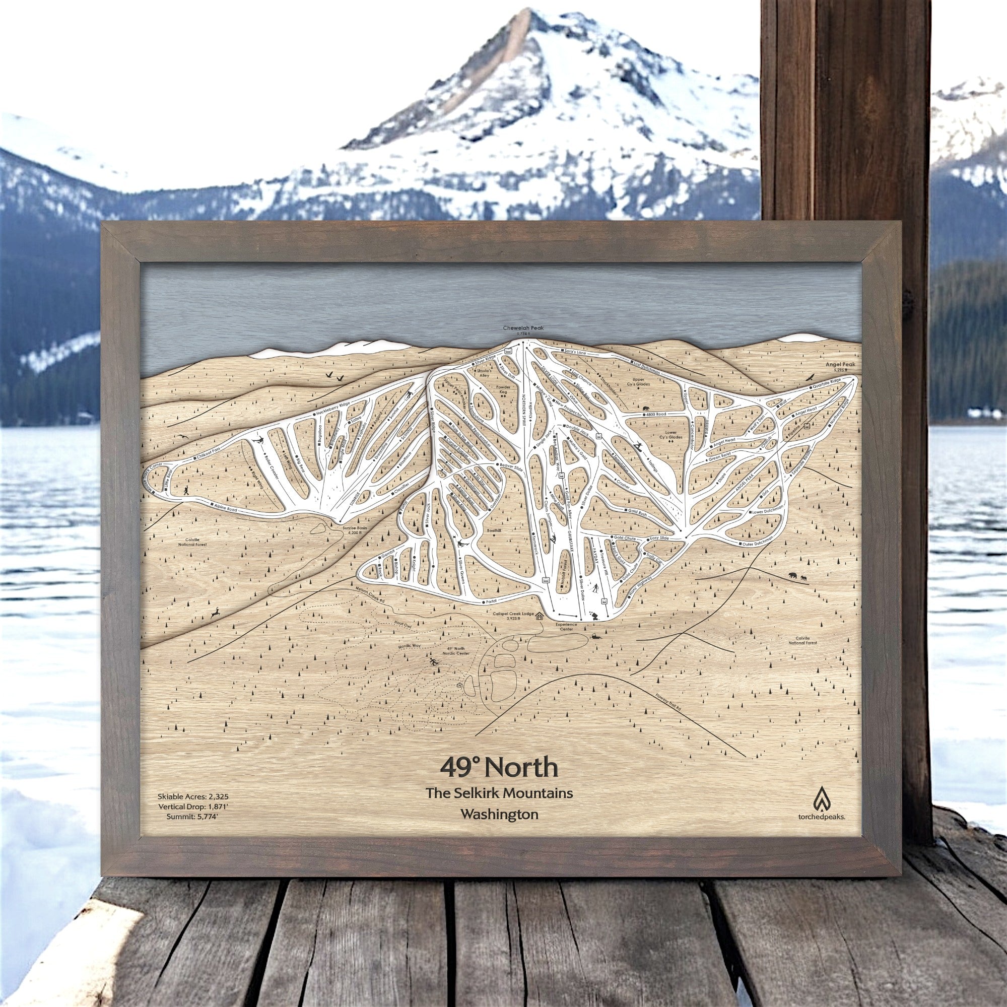 Wooden map of 49 Degrees North Ski Resort with a scenic background
