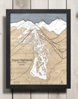 Framed map of Aspen Highlands on a wooden surface