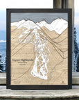 Framed map of Aspen Highlands ski area with a mountainous background