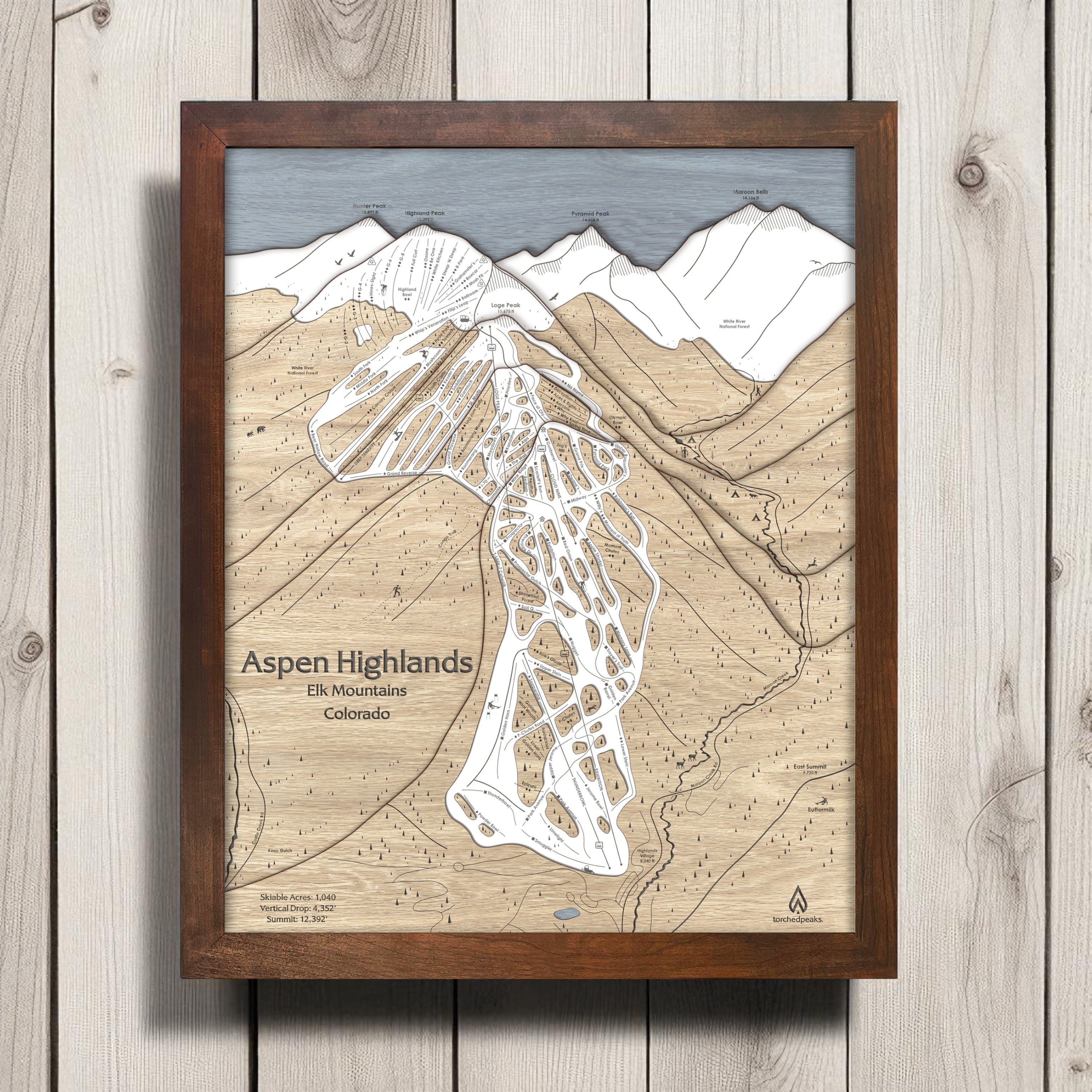 Framed map of Aspen Highlands on a wooden surface. 3D Laser-cut wooden ski map. 