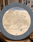 Graphite Grey Beaver Creek ski trail map cribbage board staged with playing cards and après-ski snacks.