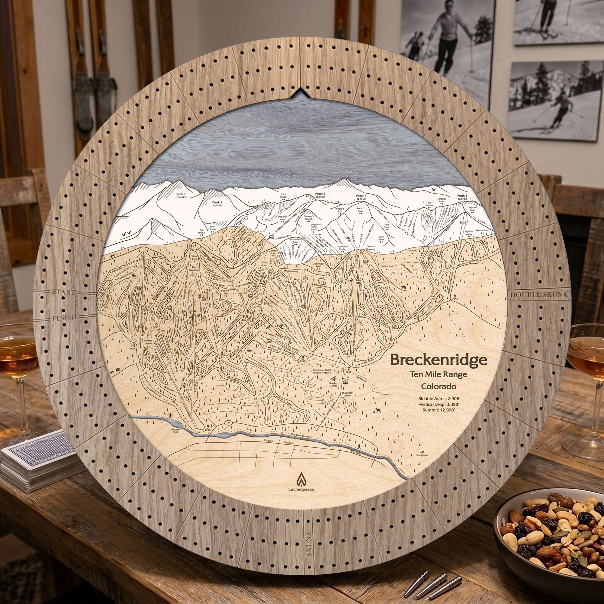 Weathered Timber Breckenridge ski map cribbage board displayed on a wooden table with cards and game-night snacks