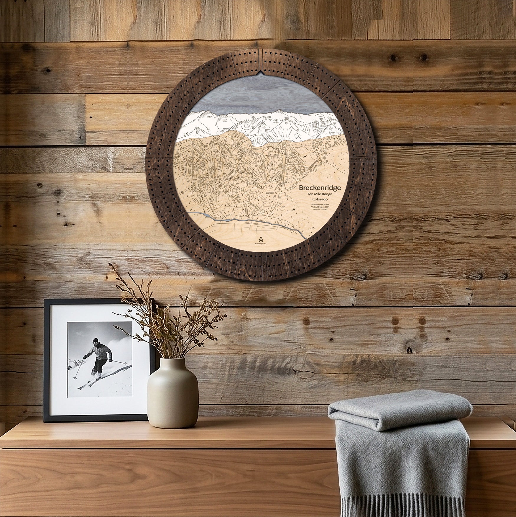 Breckenridge ski map cribbage board displayed on a reclaimed-wood wall above a console as functional ski cabin wall art