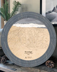 Graphite Grey Brundage Mountain wooden cribbage board displayed beside pinecones and a framed mountain photograph.
