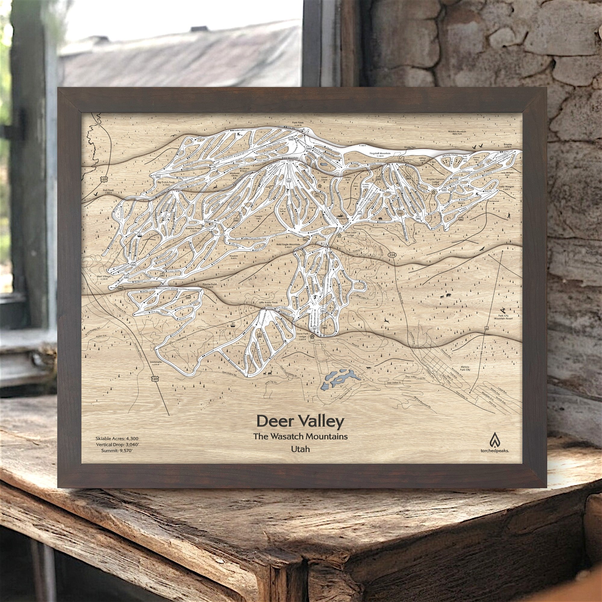 Wooden map of Deer Valley Ski Resort, Wasatch Mountains, Utah, framed on a rustic wooden frame in a ski cabin.