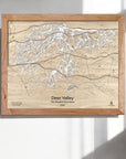 Wooden framed map of Deer Valley Ski Trails in the Wasatch Mountains on a white wall.