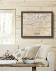 Framed 3D artwork of Deer Valley Ski Slopes on a wooden wall above a sofa.