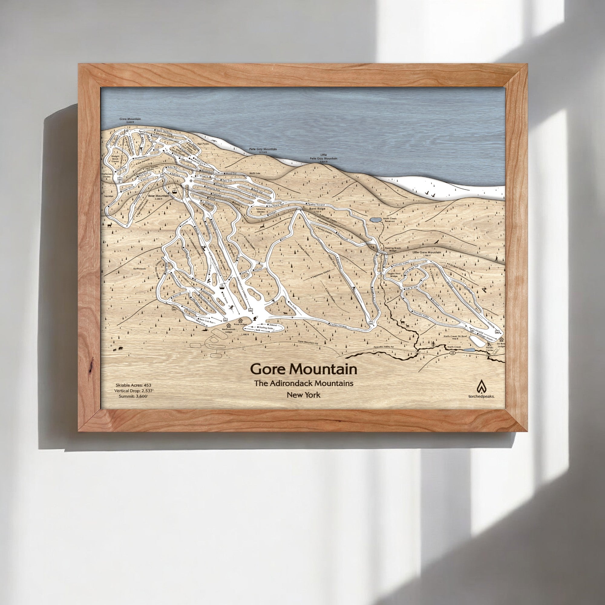 Wooden framed map of Gore Mountain, New York on a white wall