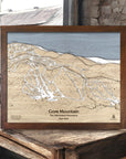 Wooden framed map of Gore Mountain, Adirondack Mountains, New York on a rustic surface inside a ski cabin. 