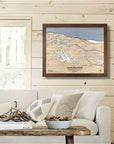 Framed map of Gore Mountain on a wall in a living room with a couch and decor.