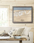 Framed topographic map of Holimont Ski Resort on a wall in a living room inside a rustic ski cabin.