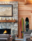 Large format artwork of Holimont Ski Resort in New York above a fireplace in a rustic ski house
