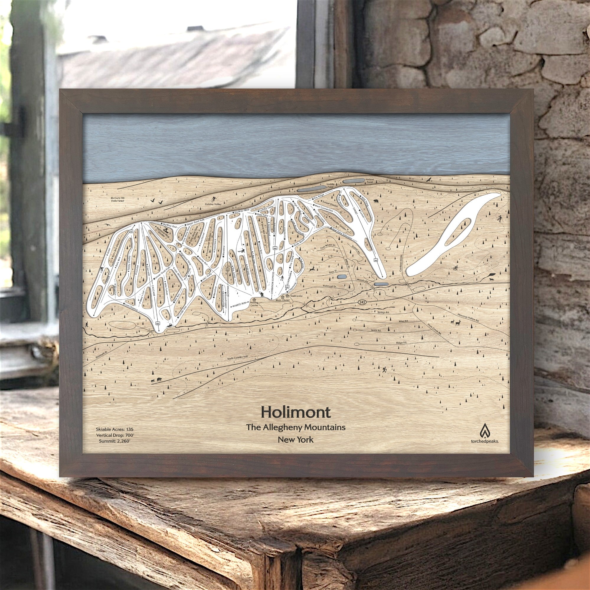 Wooden map of Holimont Ski Resort in  The Allegheny Mountains, New York, framed on a rustic wooden surface inside a rustic ski cabin. 