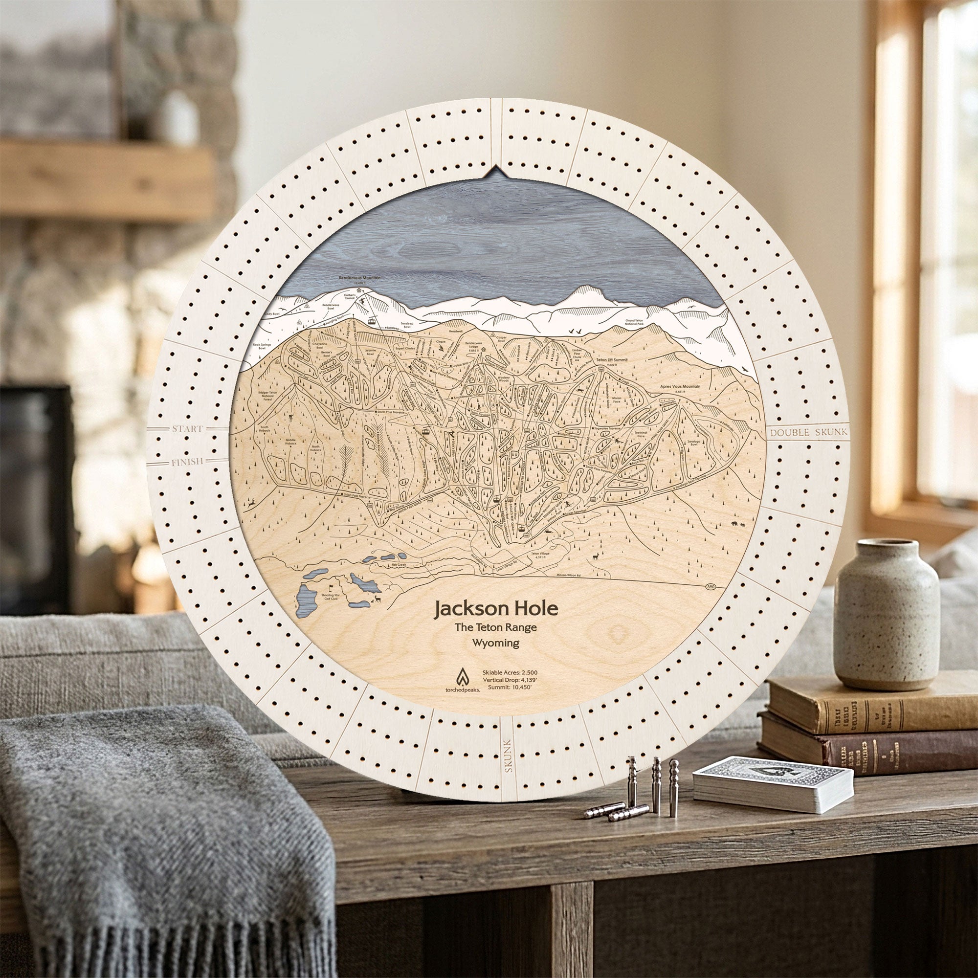 Handcrafted Jackson Hole ski map cribbage board in Arctic White displayed in a bright mountain home.