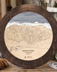 Rustic Mocha Jackson Hole ski trail map cribbage board displayed with playing cards in a mountain lodge.