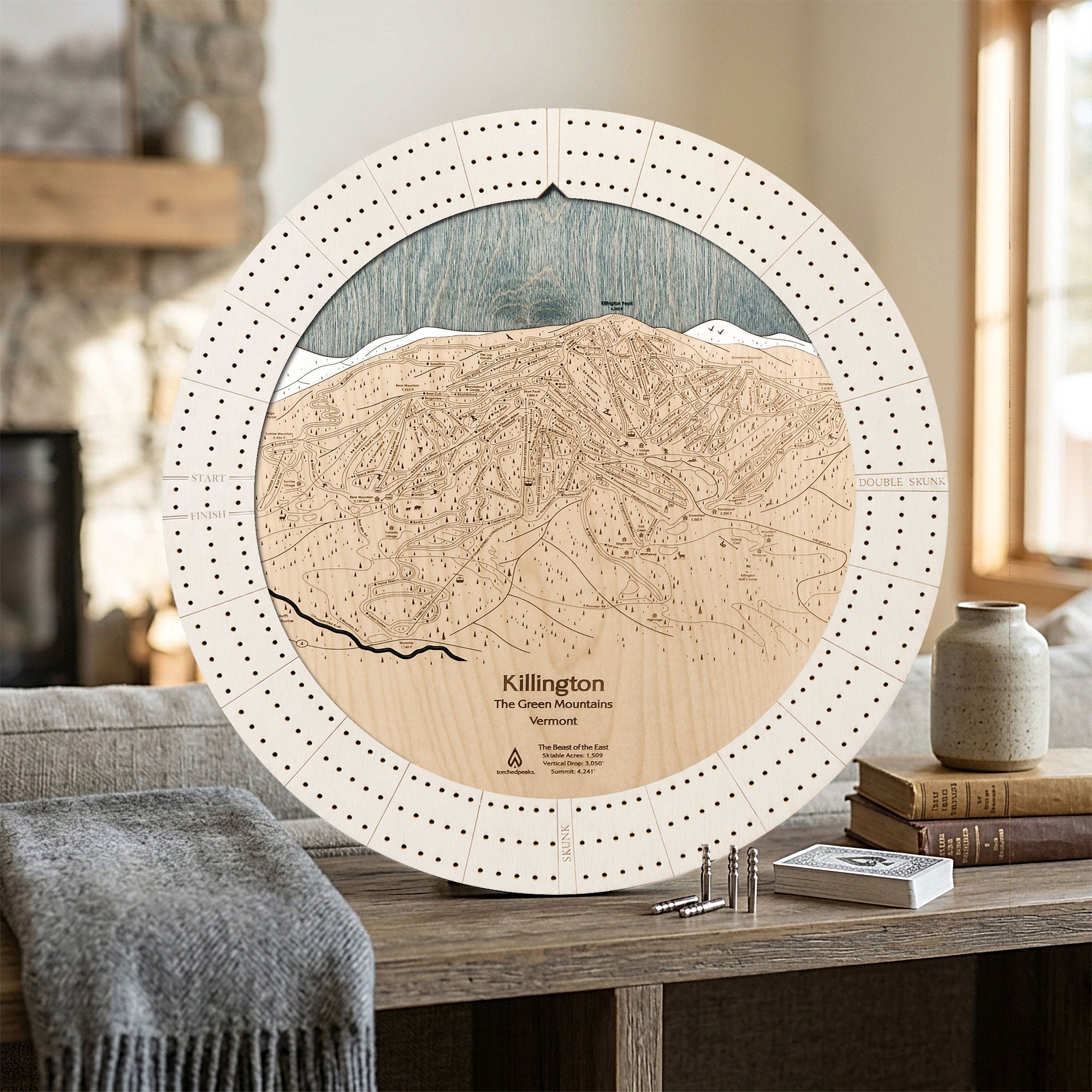 Handcrafted Killington, Vermont ski map cribbage board in Arctic White displayed in a bright mountain home.