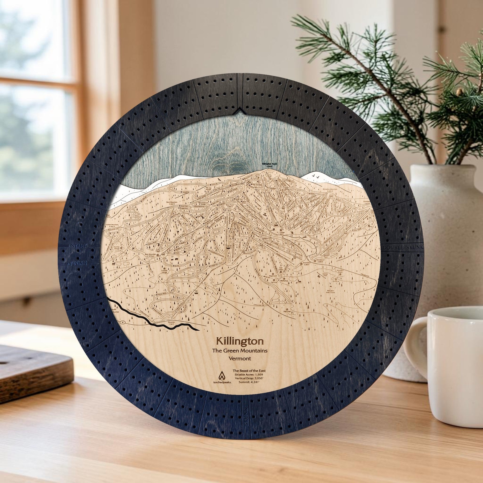 Killington Vermont wooden cribbage board in Matte Onyx displayed near a sunlit window with mountain décor.