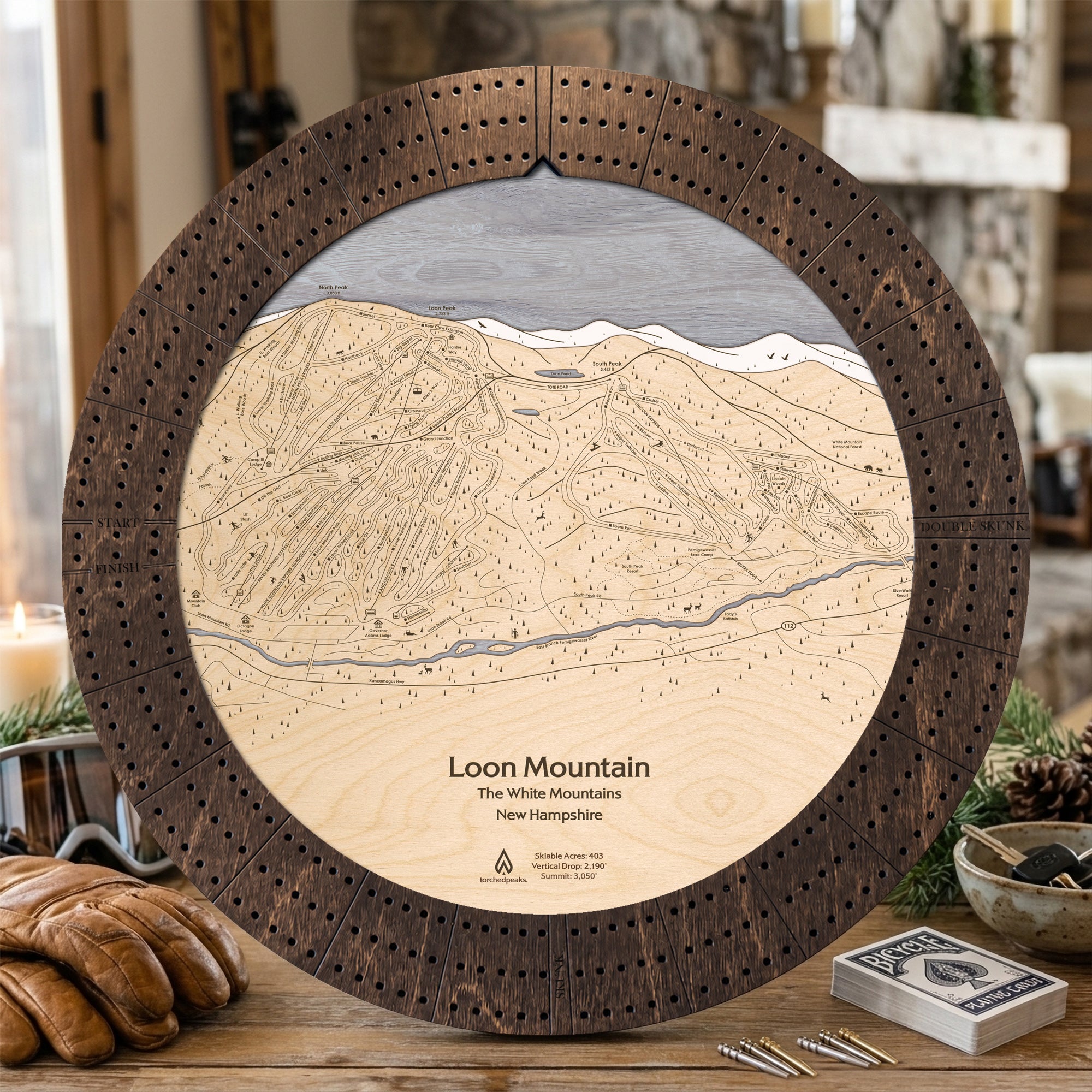 Rustic Mocha Loon Mountain wooden ski map cribbage board staged with playing cards and snacks for apres ski game night.