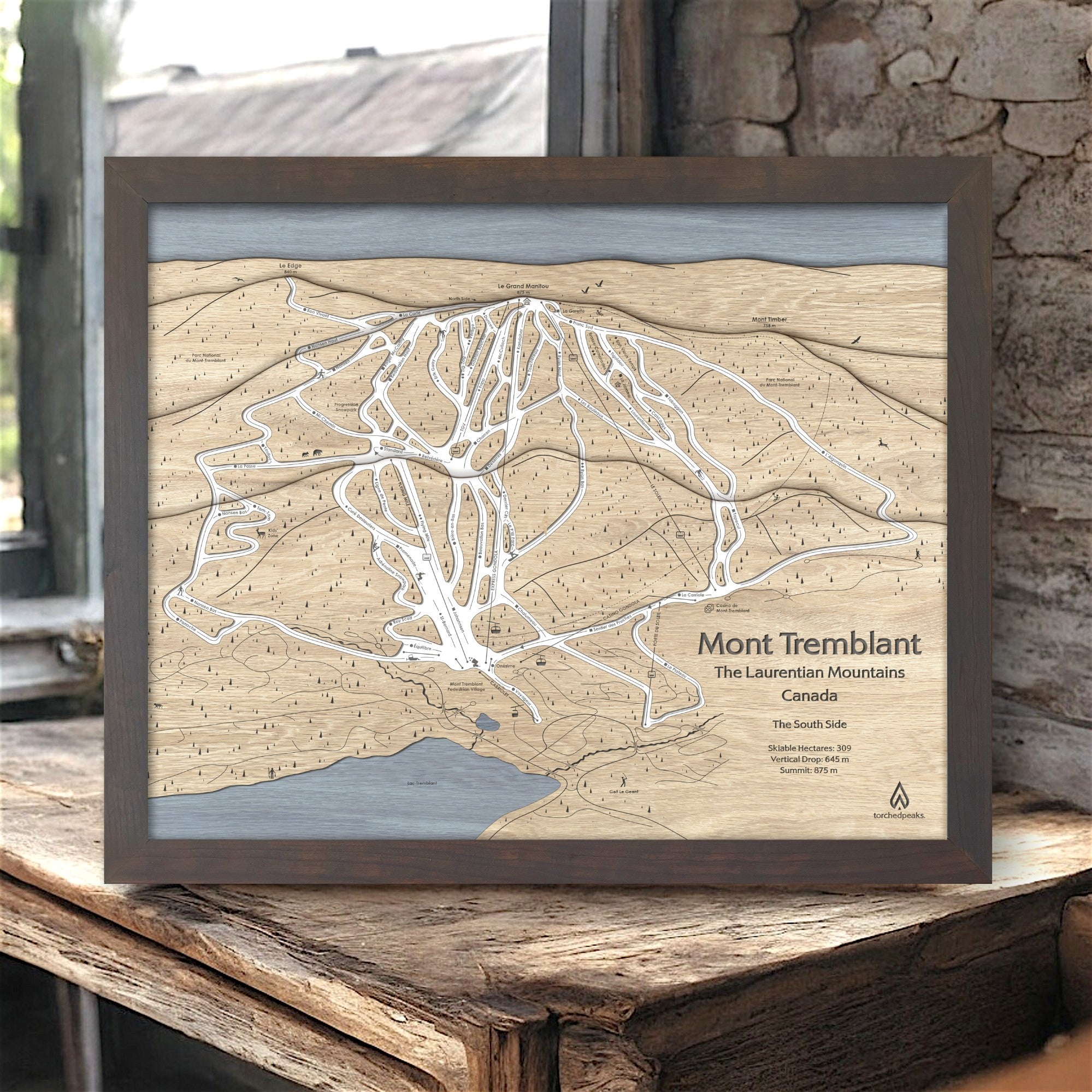 Wooden framed map of Mont Tremblant Ski Resort, Quebec on a rustic wooden surface in a ski cabin