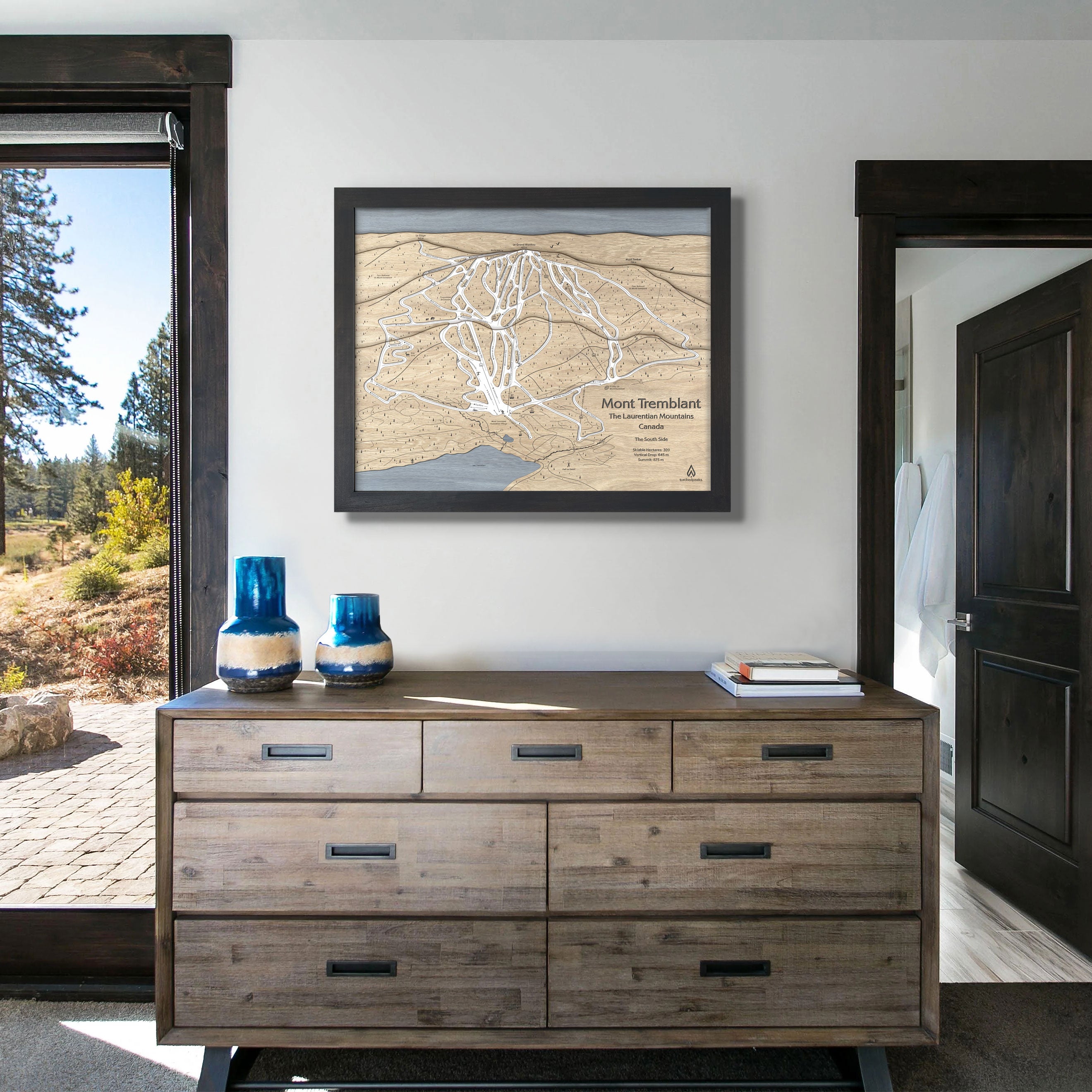 Framed wooden map of Mont Tremblant ski slopes in a ski cabin. 