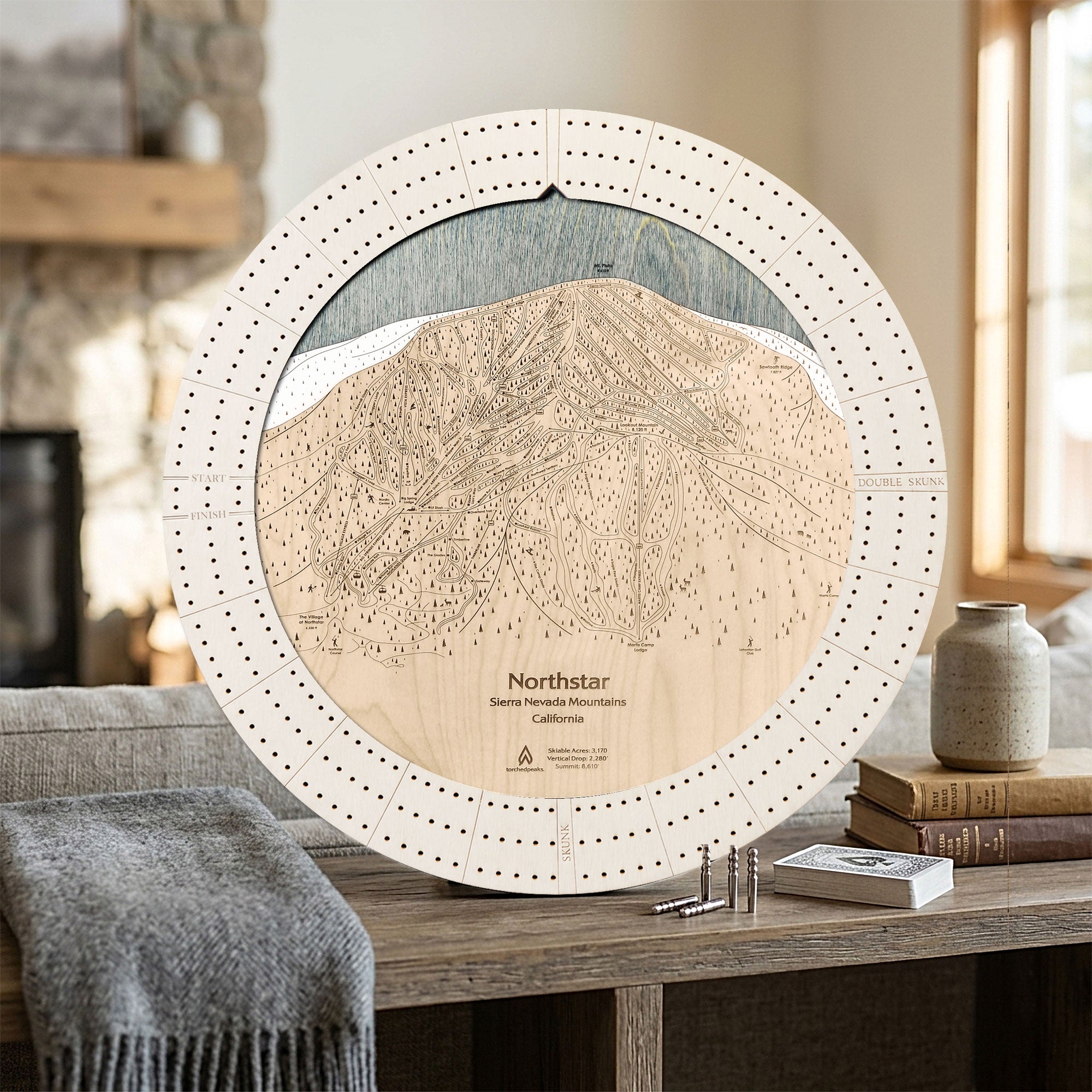 Handcrafted Northstar ski map cribbage board in Arctic White displayed in a bright mountain home.