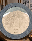 Northstar wooden ski trail map cribbage board in Graphite Grey on a rustic cabin table.