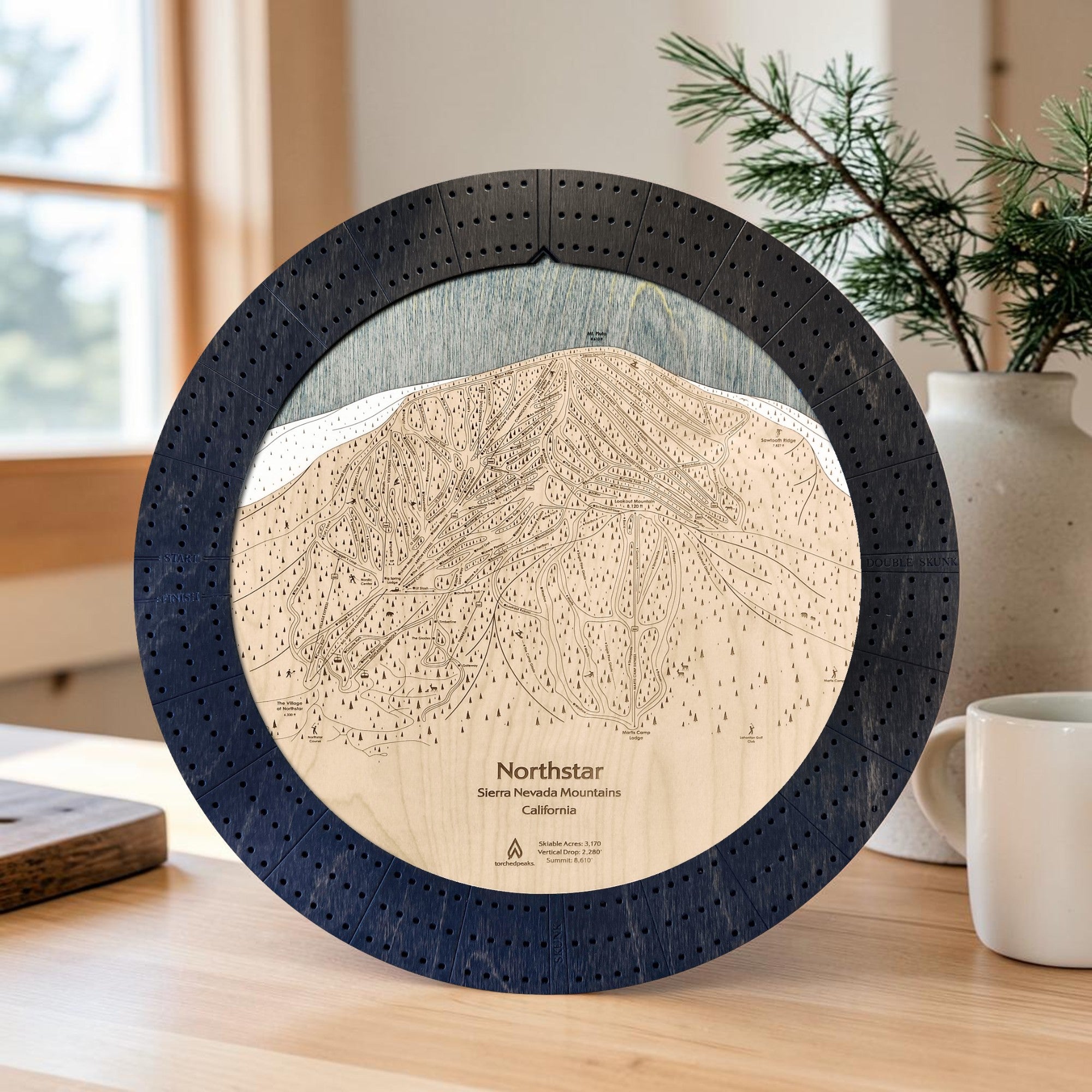 Northstar ski resort map cribbage board in Matte Onyx displayed near a sunlit window.