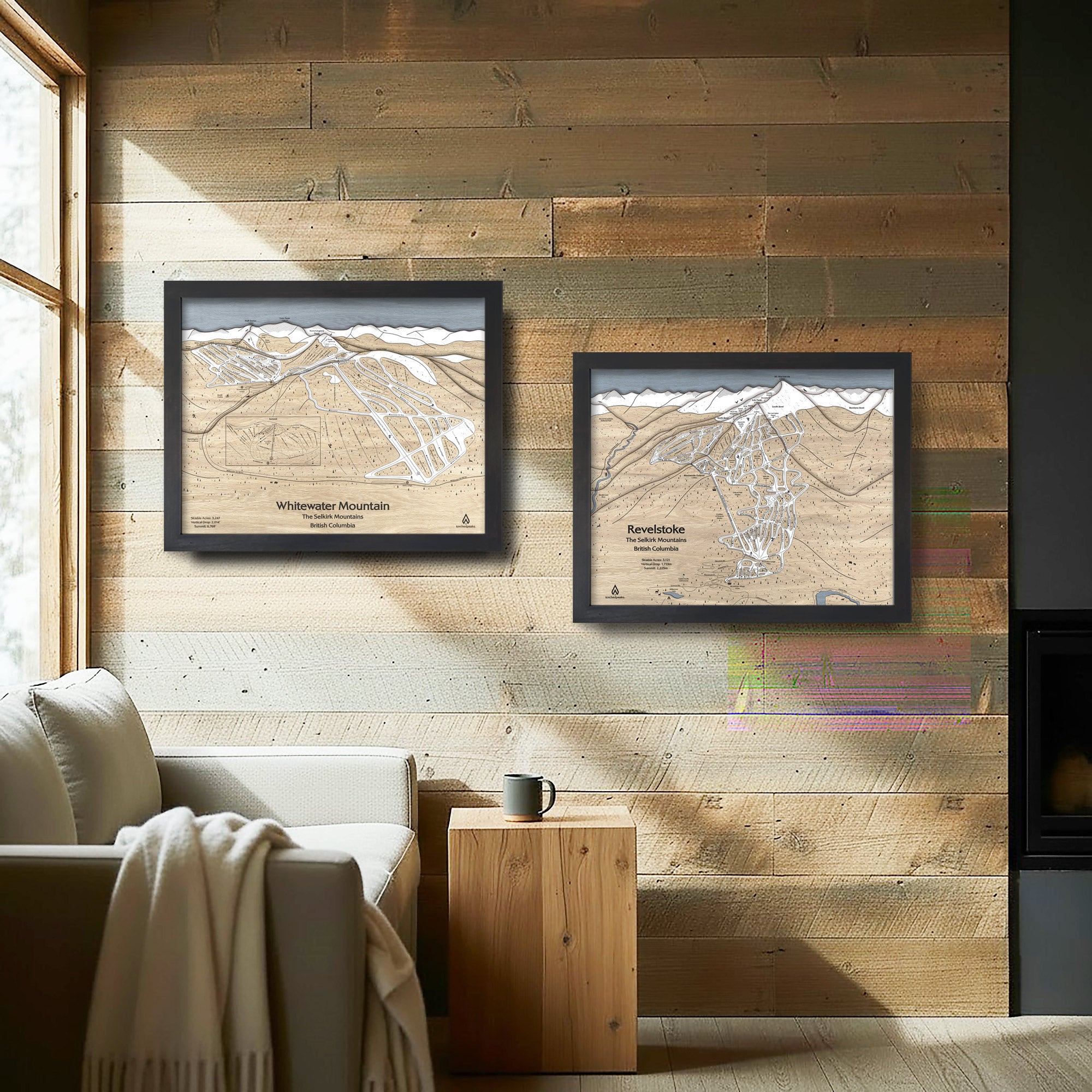 Two framed Torched Peaks Ski maps on a wooden wall with a couch and coffee table set in a rustic ski cabin. 
