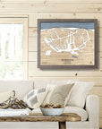Framed wooden map of butternut ski resort on a wall above a sofa in ski house.