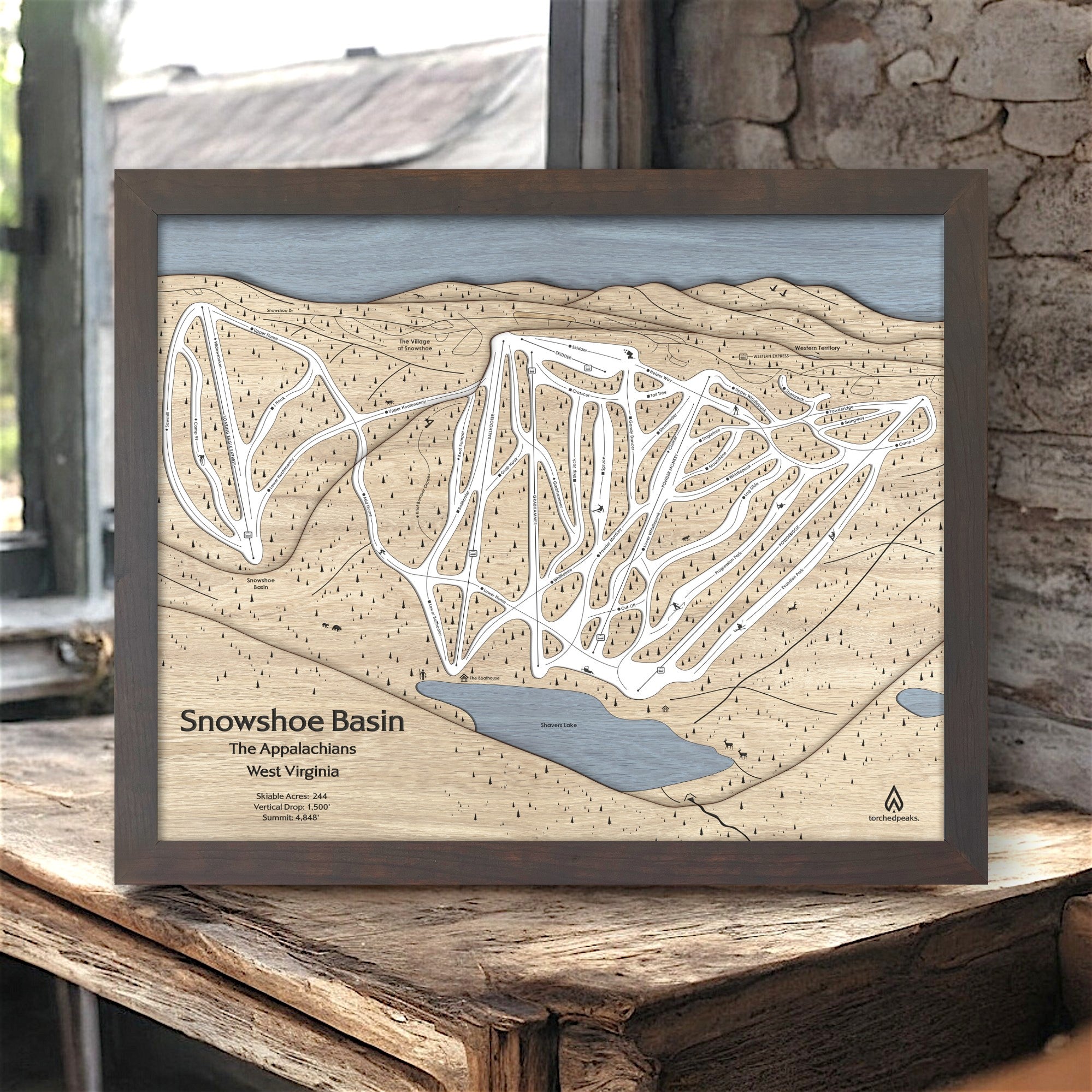 Wooden map of Snowshoe Mountain Ski Slopes in West Virginia on a wooden surface in a ski cabin.