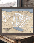 Wooden map of Snowshoe Mountain Ski Slopes in West Virginia on a wooden surface in a ski cabin.
