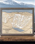 Wooden ski trail map of Snowshoe Mountain Resort with mountains in the background