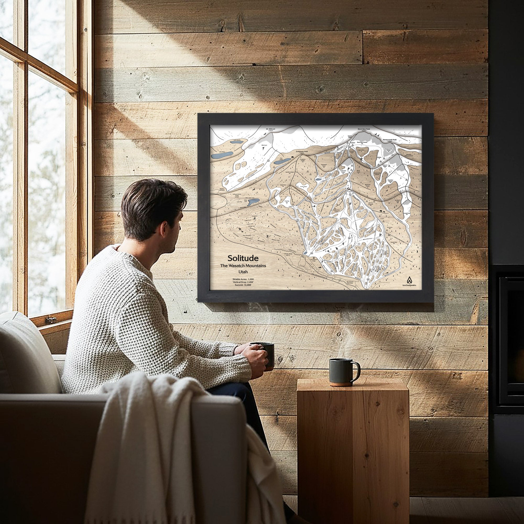 Solitude Mountain Framed Skiing Artwork on a wood wall with man admiring