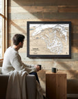 Solitude Mountain Framed Skiing Artwork on a wood wall with man admiring
