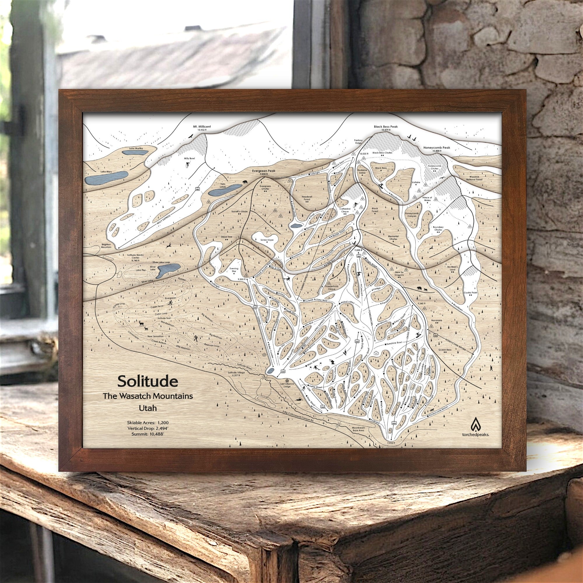 Framed topographic map of Solitude Ski Trails, in the Wasatch Mountains, Utah on a wooden surface.